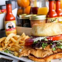 Crispy Fish Sandwich · White fish fried crispy to perfection on a vegan bun, topped with mixed greens, tomatoes, re...