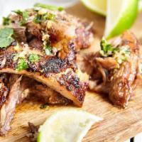Lechón Asado – Slow Roasted Pork · Classic Cuban Slow Roasted Pork, topped with chopped cilantro, lime, or spicy salsa. With yo...