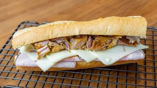 Cuban Sandwich · Authentic Cuban sandwich made with Cuban bread, mayo, mustard, ham, cheese, pickles, and pork.