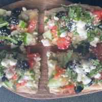 Mediterranean Flat Bread · Flat bread with hummus, cucumber, tomatoes, black olives, feta cheese and fresh basil.