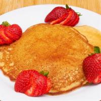 Homemade Pancakes · Garnished with fresh fruit.