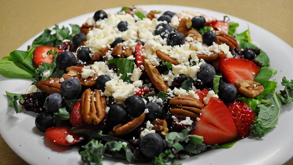 Spring Salad · Deliciously healthy salad served with fresh mixed greens, spinach, strawberries, blueberries, dried cranberries, pecans and  feta cheese, served with (2)  raspberry walnut vinaigrette  dressings on the side