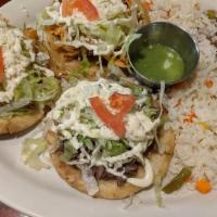 Steak Or Chicken Sopes · Three thick corn tortillas topped with refried beans, steak or chicken, lettuce, tomatoes, C...