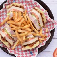 Club Sandwich · Toasted bread with ham, turkey, bacon, cheese, lettuce, and tomato with mayo. Served with fr...