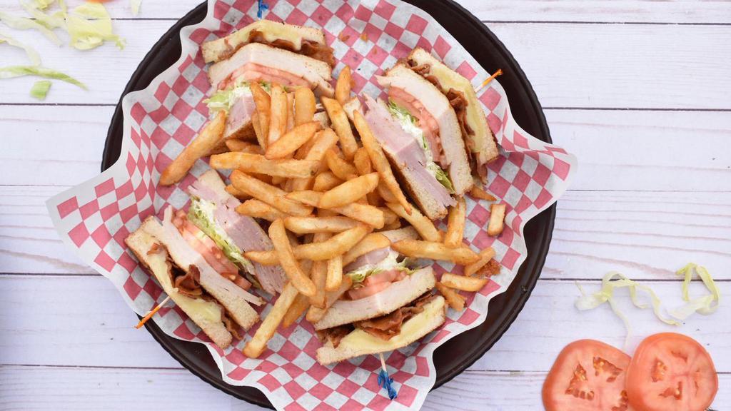 Club Sandwich · Toasted bread with ham, turkey, bacon, cheese, lettuce, and tomato with mayo. Served with fries.