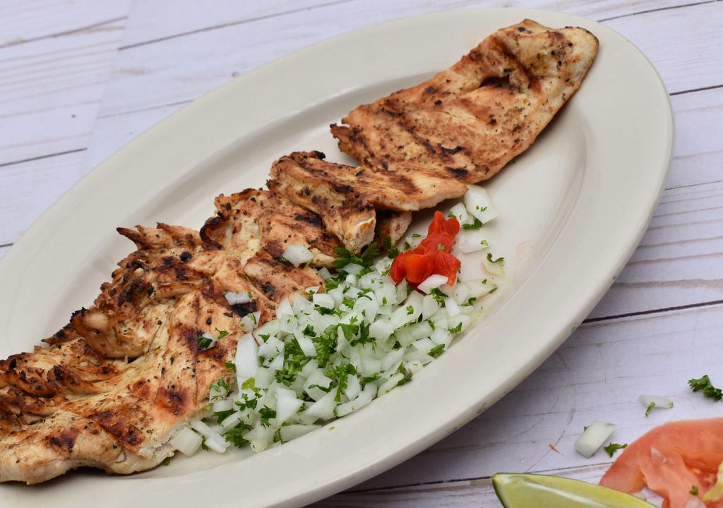 Churrasco De Pollo · Chicken breast, marinated in herbs and spices, served with chimichurri sauce.