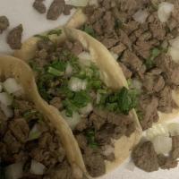 Cochinita Pibil Tacos · From merida, Yucatan, Shredded, seasoned pork with pickled habanero red onion.