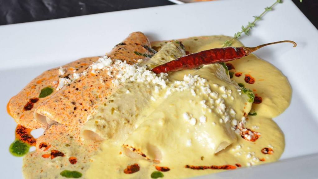 Bicentenario Enchiladas · Filled with gourmet picadillo and topped with three of chef Omar's famous sauces and fresco cheese. Served with rice and beans.