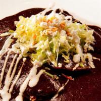 Mole Xico Enchiladas · Filled with seasoned chicken breast and topped with mole xico, lettuce, sour cream and chees...
