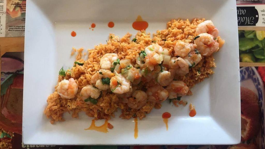 Arroz Con Camarones · Mexican rice, and shrimp tossed in a habanero and cilantro sauce (spiced).