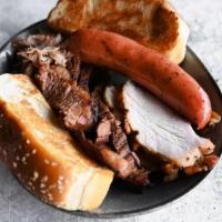 City Sampler · Beef brisket, pulled pork, sausage, turkey, two sides, and Texas toast