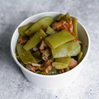 Green Beans With Bacon · Kentucky Wonder beans, onions, smoked bacon, and cracked black pepper