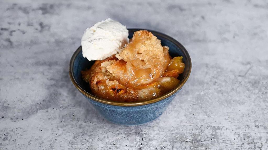 Peach Cobbler · A ton of peaches in a gooey, caramelized crust, served with hand-whipped cream