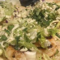 Shrimp Tacos · Three soft corn tortillas filled with fresh grilled shrimp, lettuce, cilantro and topped wit...