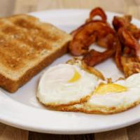 Bacon Eggs · Huevos soleados, tiras de tocino y tostadas de trigo integral.