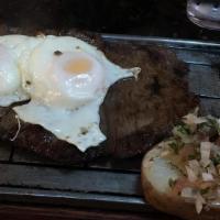 Bistec A Caballo · Grilled steak with eggs.