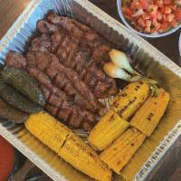 Jalisco Family Meal · 4 Prime NY strip steaks with baby onions and grilled corn on the cob. large Mexican Rice, la...