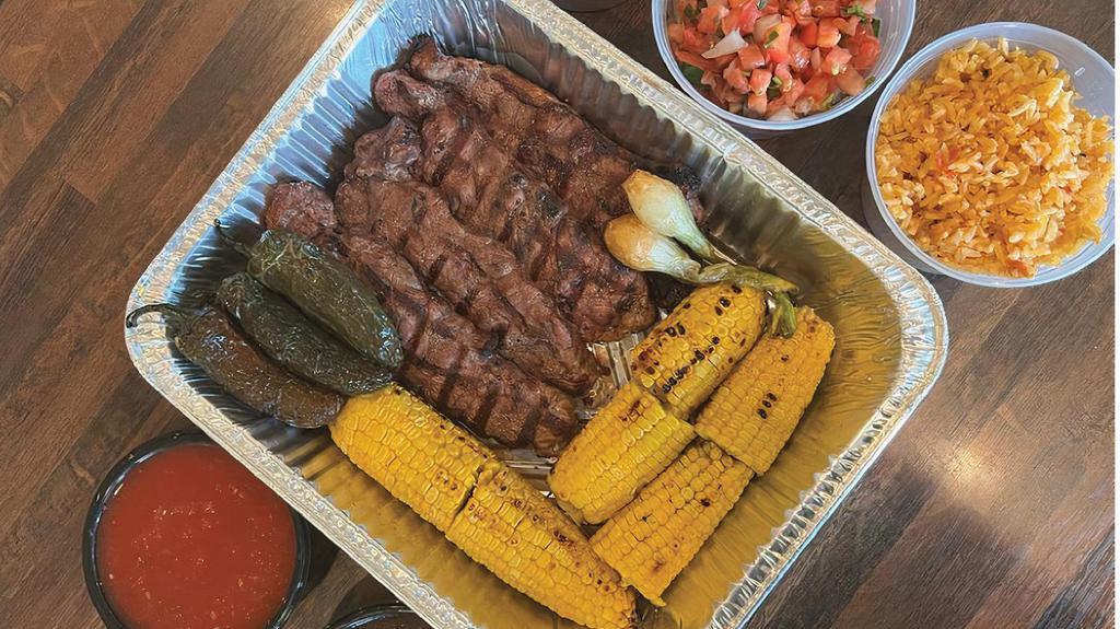 Jalisco Family Meal · 4 Prime NY strip steaks with baby onions and grilled corn on the cob. large Mexican Rice, large Refried Beans, Chips and Salsa / Feed 4 to 6 people