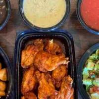 Appetizer Family Meal · Our most popular appetizers in one Family meal, 10 Frontera wings, Homestyle guacamole, a la...