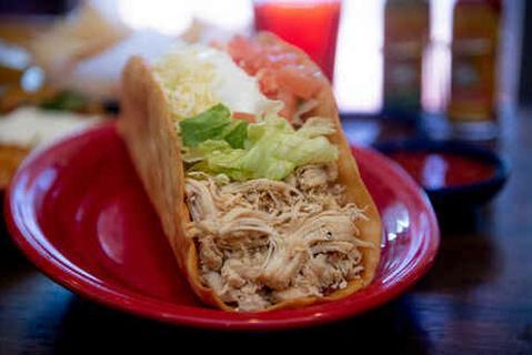 Crazy Taco · Jumbo flour tortilla shell stuffed with shredded chicken or ground beef, fresh lettuce, tomatoes, cheese, and sour cream.
