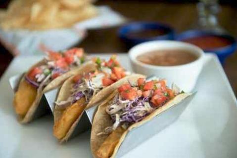 Ensenada Fish Tacos · Lightly battered and fried cod fish or grilled tilapia with your choice of corn or flour tortillas, topped with fresh Mexi-slaw. Served with charro beans.