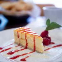 Passion Mango Cheesecake · Smooth passion fruit and mango infused buttermilk cheesecake topped with strawberry sauce.