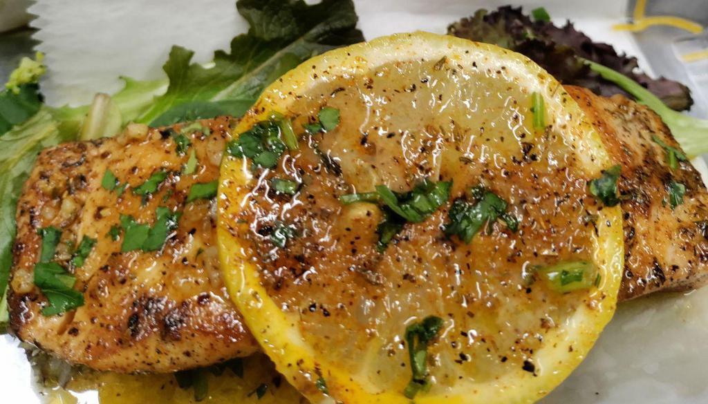 Lemon Garlic Herb Grilled Salmon · Garlic butter, lemon, and fresh herbs are blended to create this savory salmon dish, served with your choice of two sides.