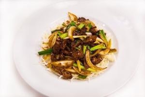 Ad7 - Mongolian Dinner · Tender slices of beef stir-fried with green and white onion in a savory brown sauce and serv...