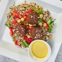 Quinoa Salad With Falafel · Tricolor quinoa, chickpeas, red and green peppers, cherry tomatoes and signature dressing.