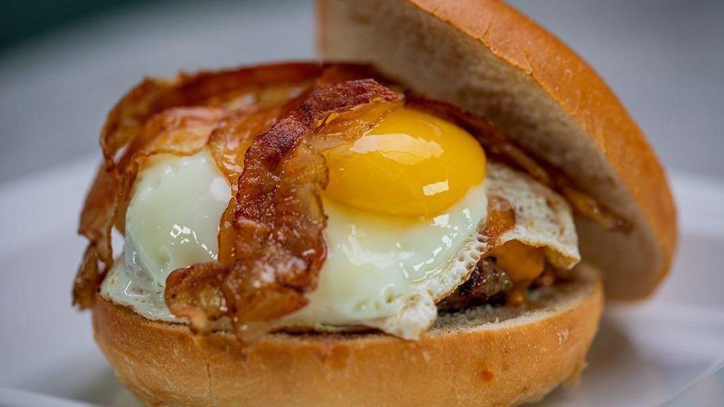 Breakfast Burger · 8 oz signature blend, Cheddar cheese and applewood bacon, single fried egg sunny side up.