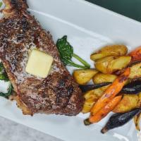 12 Oz New York Steak · Charred to perfection. Served with fingerling potatoes, baby carrots, red peppers, spinach a...