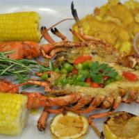 Woma Griye - Grilled Lobster · Served with 2 pieces of corn, 2 plantain, Red Beans & Rice or White Rice & Black Beans, Sala...