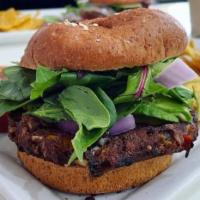 Black Bean Burger · Mixed greens, avocado slices, diced tomatoes, purple onions, grilled black bean burger, vegg...