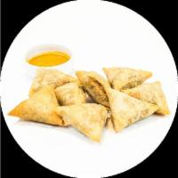 Fried Samosa (8) *Vegetarian · (8 pieces) Curry potatoes, chick peas, onions, lentils, served with curry sauce. (Vegetarian)