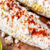 Elote/ Street Corn · Corn on the cob dressed in mayo, butter, cheese, and spice if you like.