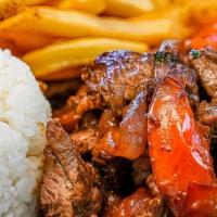 Lomo Saltado · Tender beef sauteed with onions and tomatoes in a soy sauce marinade. Served with white rice...