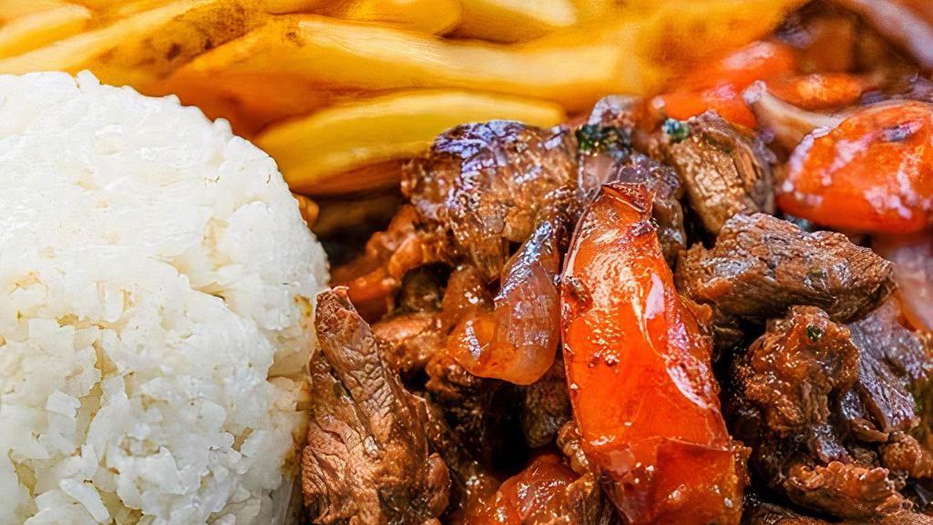 Lomo Saltado · Tender beef sauteed with onions and tomatoes in a soy sauce marinade. Served with white rice and french fries.