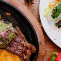 Carne Aguacatala · Grilled NY steak. Served with white rice, tostones, guacamole, and salad.