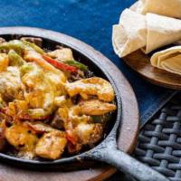 Fajitas Los Tres Amigos · Grilled steak, chicken, and shrimp topped with onions, peppers, and cheese. Served with flou...
