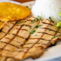 Trucha · Grilled or fried trout butterflied. Served with rice, green plantains and salad.