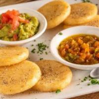 Arepitas Paisas Con Guacamole Y Hogao · Fried mini Colombian arepas with guacamole and a Colombian sauce made of tomatoes, scallions...