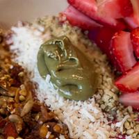 Pitaya Bowl · Pitaya, banana, strawberries, coconut milk, maca, lucuma. Topped with strawberries, hemp see...