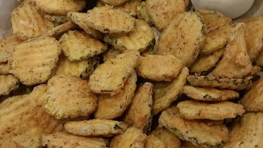 Fried Pickles · Sliced crinkle cut pickle chips, lightly breaded & fried golden-brown. Served with Cajun ranch dressing.