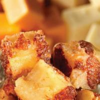 Cheese Curds · Melted, cheesy curds golden battered and fried for a perfect crispy treat!  Served with mari...
