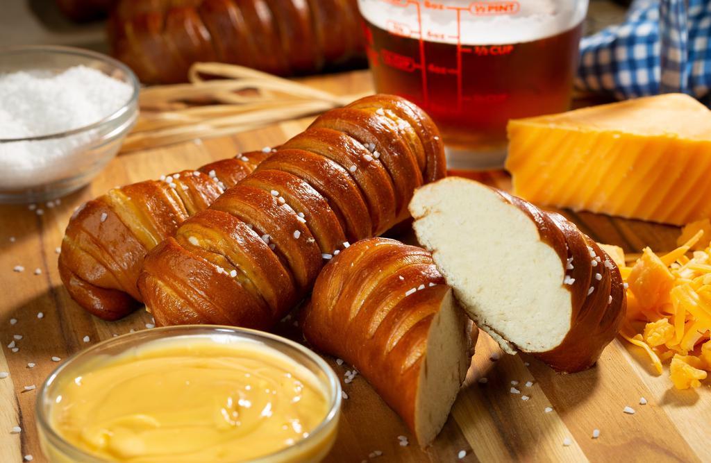Pretzel Sticks · Three golden, soft-baked pretzels lightly brushed with our Gold Rush sauce and crunchy salt crystals. Served with creamy beer cheese and our new Bumblebee sauce - sweet with a tiny bit of heat.