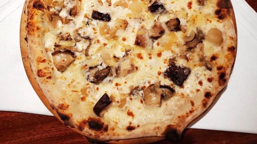 Funghi Pizza · Light truffle bechamel, local wild mushrooms, cipollini onions, and fontina cheese.