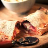 Three Little Pigs Calzone · Calzone filled with bacon, ham, pepperoni, and three cheese. Served with a side of sauce.