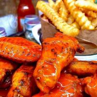 Bone-In Wings - 24 · Jumbo bone-in chicken wings, deep fried and tossed in any of our signature sauces or dry rub...