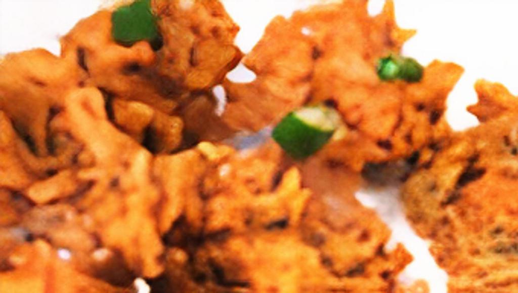 Mixed Vegetable Pakora · Mixed vegetables dipped in chickpeas batter and deep fried.