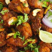 Bhemavaram Kodi Vepudu · Bone in chicken marinated with Andhra spices with onions, chilies, cashews, and fried.